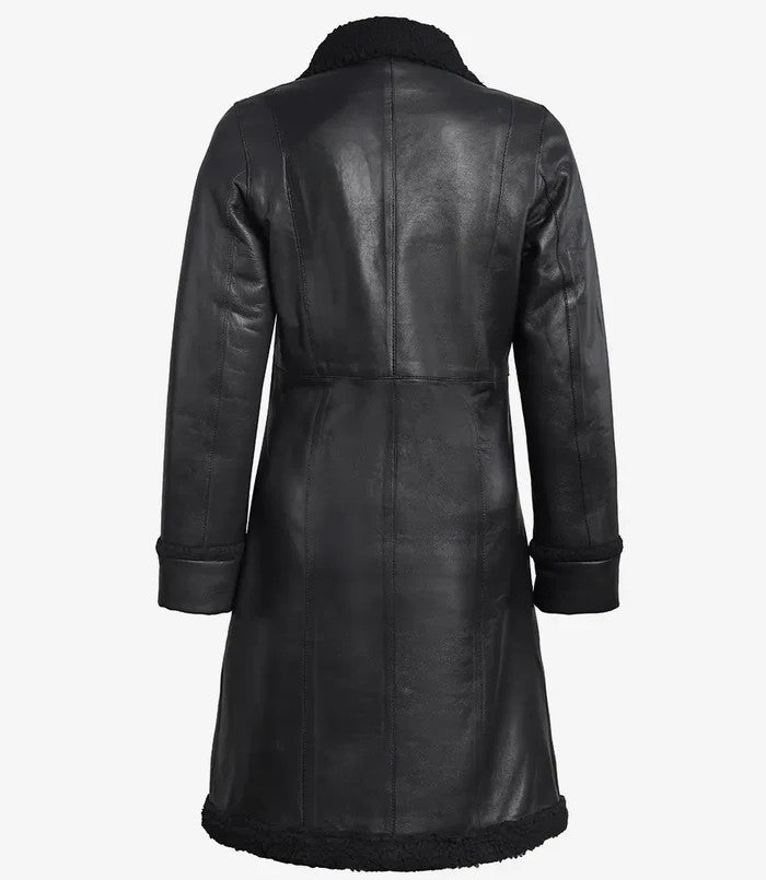 Back view of women’s black shearling long leather coat